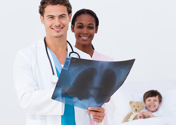 Two Pediatric Doctors with a young kid